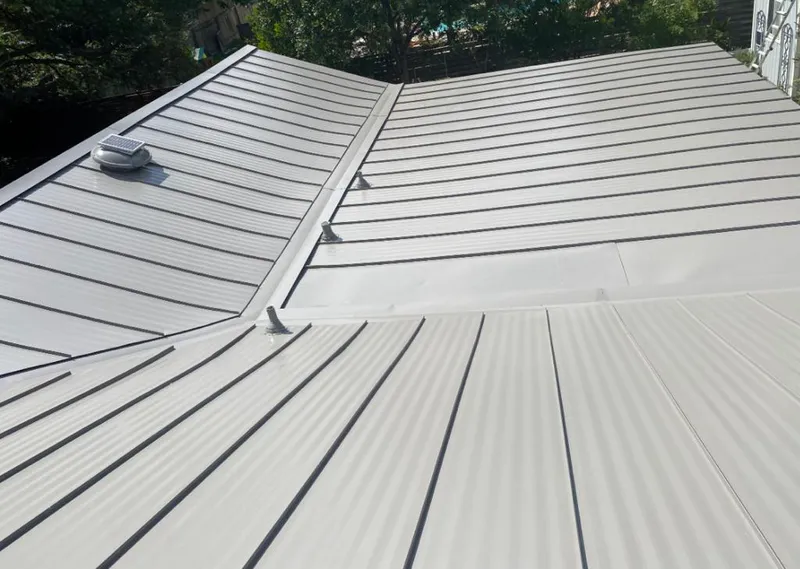 Solar attic fan installed on a metal roof for Roof Ventilation in Orange Park