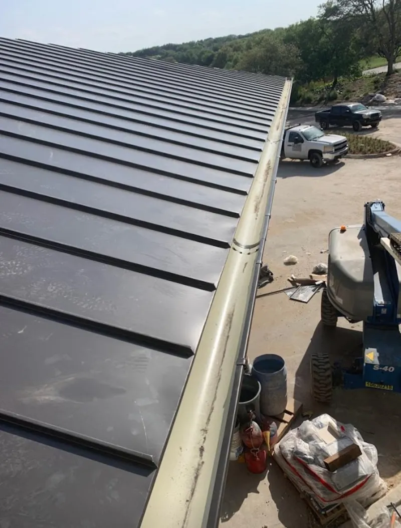Standing seam panel and gutter detail on a metal roofing jobsite in Orange Park